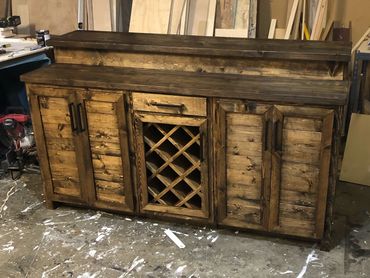Custom rustic wood bar with wine rack and two storage areas for liquor and other bar necessities.