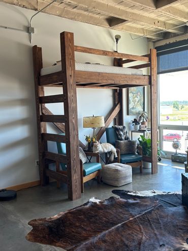 Custom lofted bed with lounge area underneath, built by Henry's Legacy Woodworking.