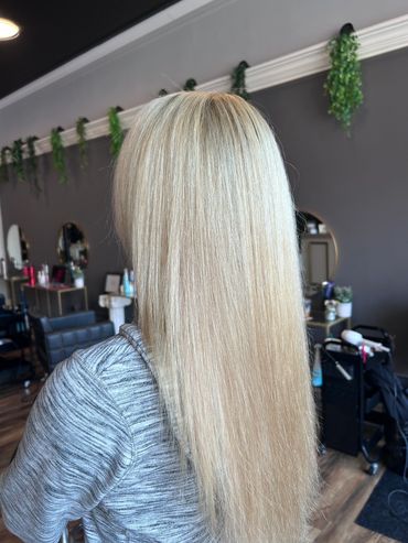 Smooth, straight blonde hair in a salon.