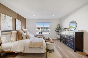 Bright and cozy bedroom with neutral tones and modern decor.