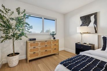 Modern bedroom with natural wood furniture and minimalist decor.