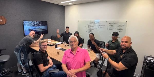 Group of men in a meeting room posing for a photo.