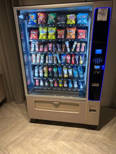 A well-stocked vending machine with snacks and drinks.