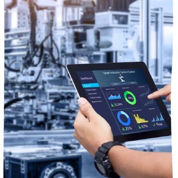 Person using a tablet with a smart industrial control dashboard in a factory.