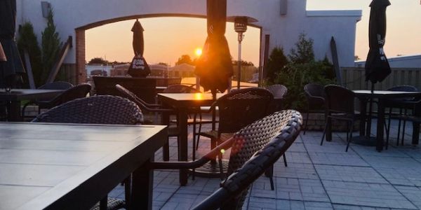Empty outdoor seating area at sunset.