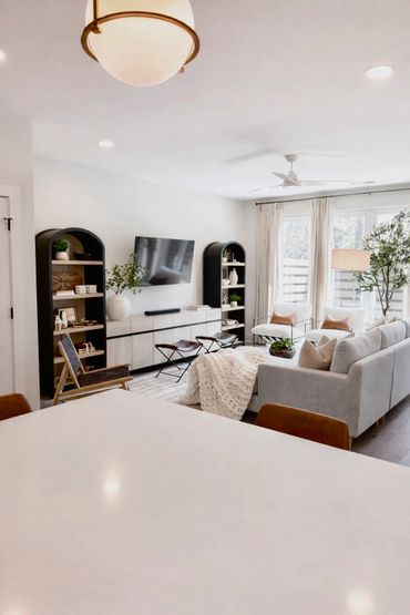 Bright and cozy living room with modern furniture and large windows.