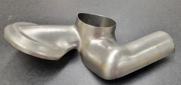 Metal pipe component with smooth bends and a round opening.