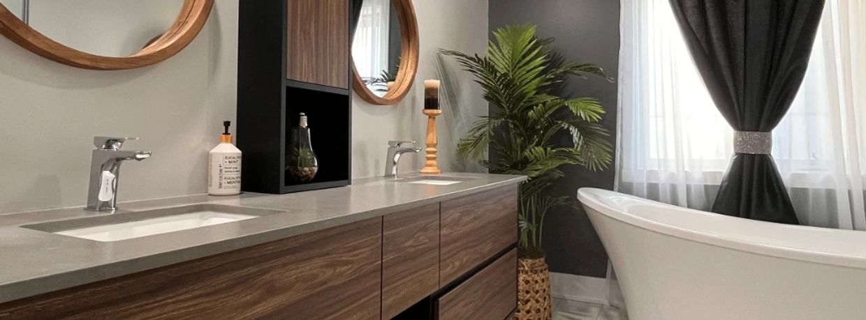 Modern bathroom with wooden vanity, round mirrors, and freestanding bathtub.