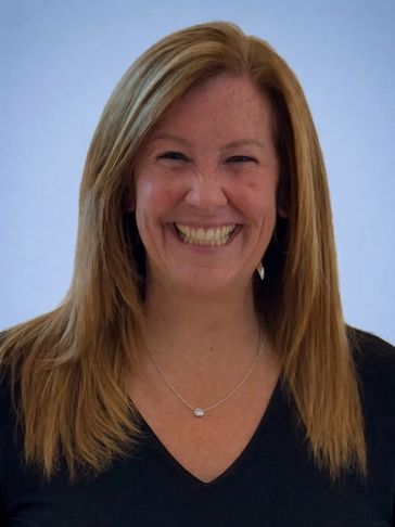 Smiling woman with straight blonde hair and a black top.