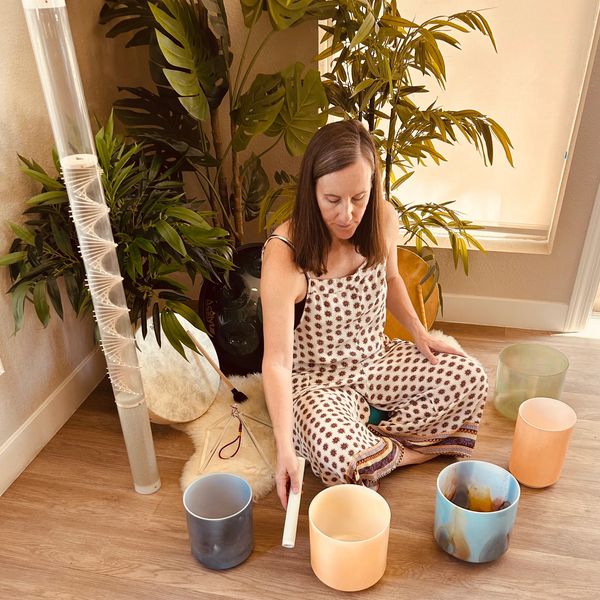 Mary from Pure Presence Events playing crystal bowls during a sound healing in Phoenix, Arizona.