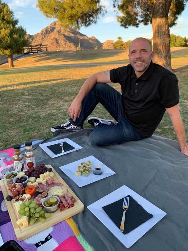 Chef Ben, co-founder of Pure Presence Events, preparing gourmet picnic dishes in Phoenix, Arizona.