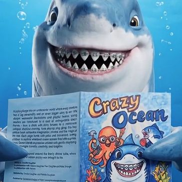 Smiling shark with braces holding a book titled Crazy Ocean.