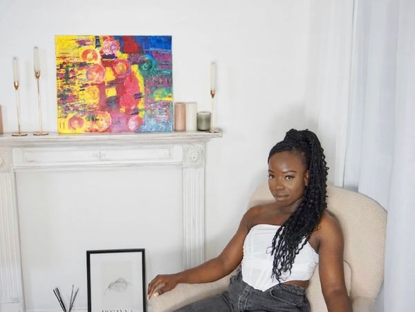 Amie Wolo with her abstract artwork