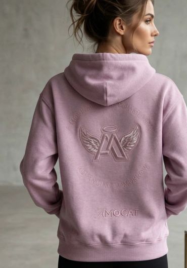 Woman in pink hoodie with winged logo design.