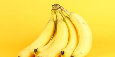 Yellow background with five yellow bananas