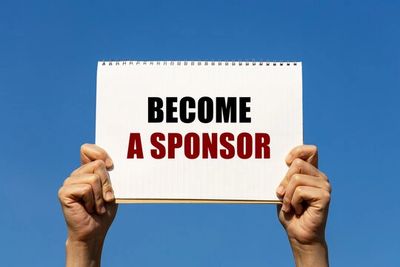 Hands holding a sign that says 'BECOME A SPONSOR' against a clear blue sky.
financial support for students
leadership programs
student sponsorship