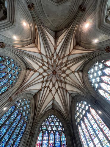 The stunning Wells Cathedral with arched ceilings and stained glass windows. Begun in the late 1100s