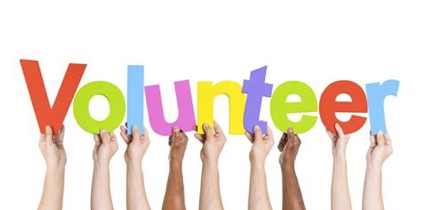Diverse hands holding colorful letters spelling 'Volunteer'.