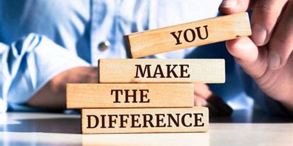 Wooden blocks with the message 'You make the difference' being arranged by a person.