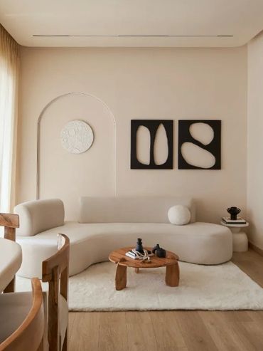 Minimalist living room with neutral tones and wooden accents.