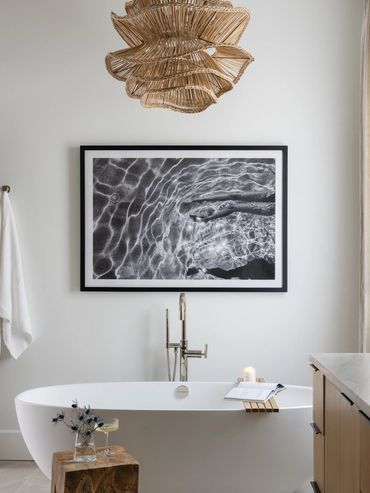 Modern bathroom with a freestanding tub and artistic decor.