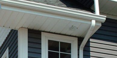 white Gutter soffit and downspout on blue home