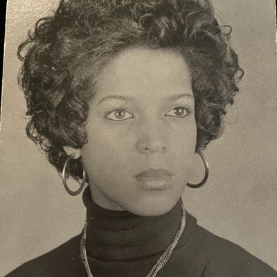 Black and white portrait of a woman with curly hair.