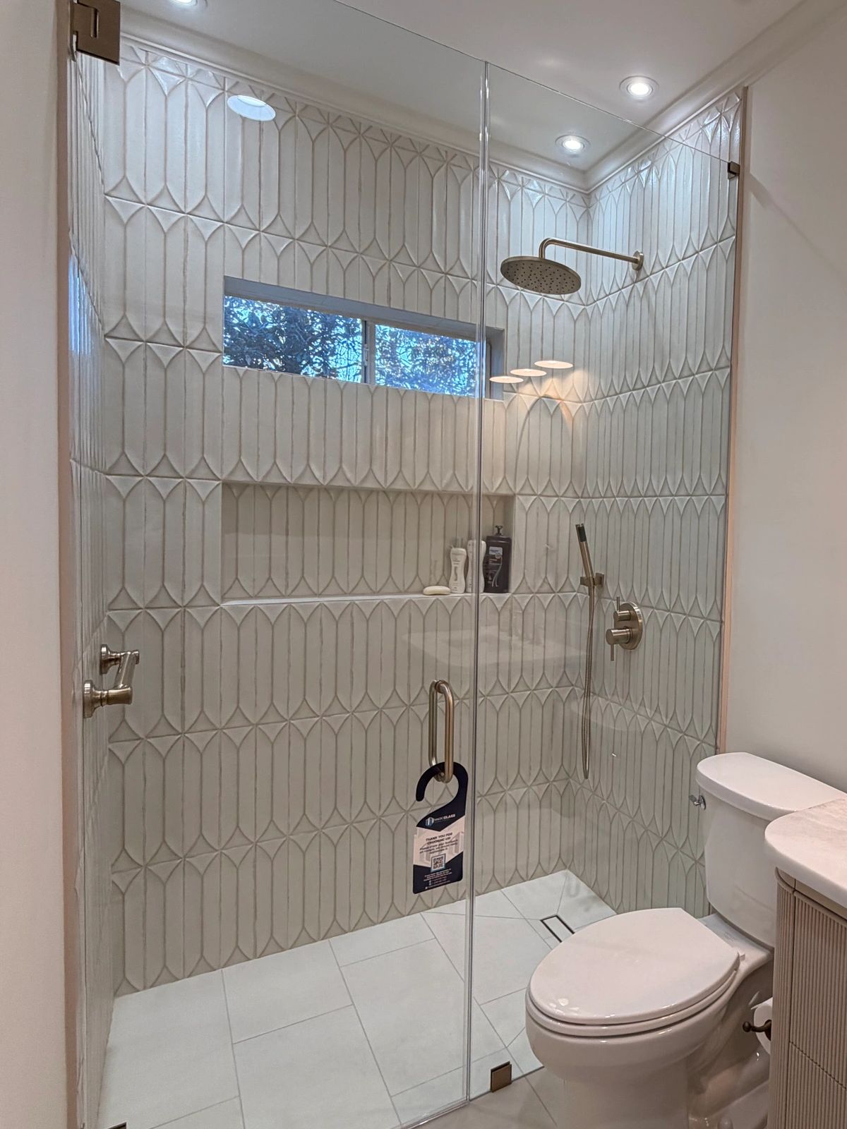 Frameless glass enclosure with dark brushed bronze hardware