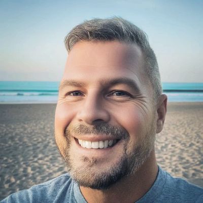 taking a selfie on the beach at sunset.