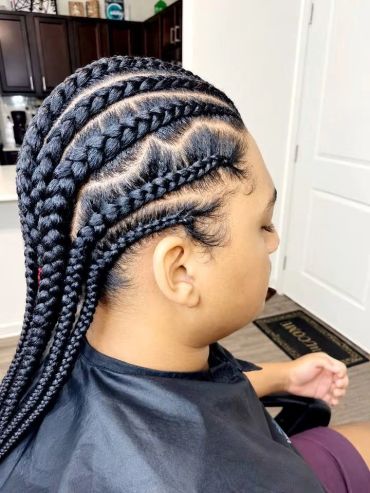 Side view of a person with detailed cornrow braids hairstyle.