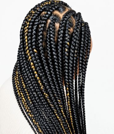 Detailed view of black and gold twisted box braids hairstyle.