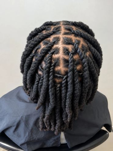 Neatly twisted and parted natural hair style.