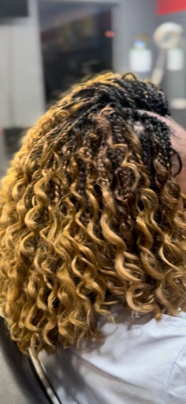 Curly ombre hairstyle with braids on top.