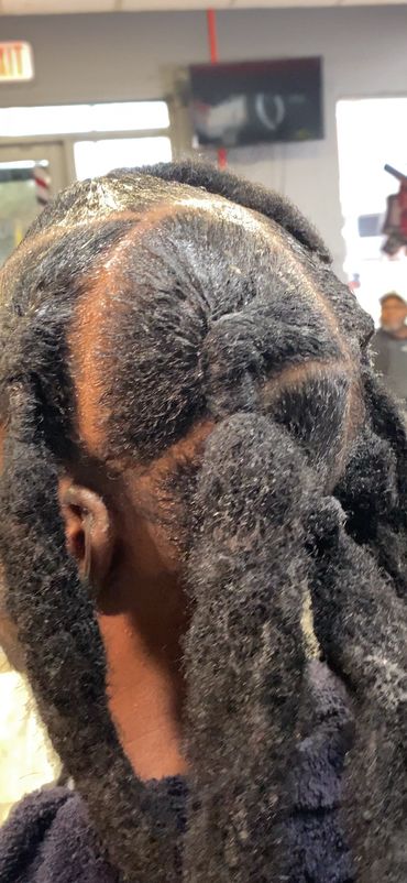 Close-up of a fresh, neatly parted hairstyle with thick, textured twists.