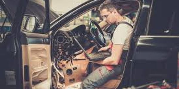 A man checked the car for on the laptop