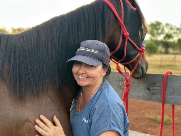 Woman hugging a horse.