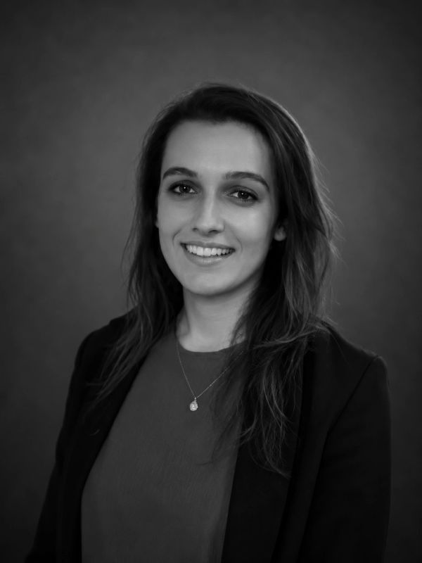 Black and white portrait of a smiling woman.