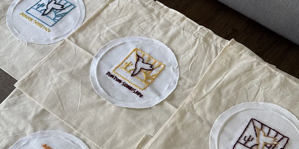 Embroidered patches with bird designs on fabric.