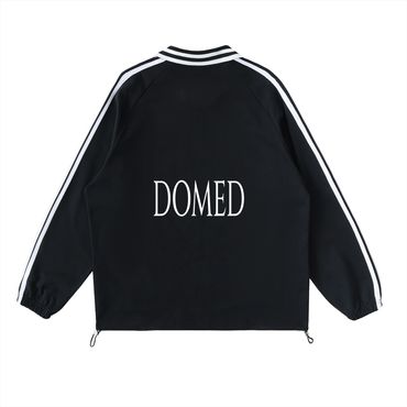 Black jacket with white stripes and 'DOMED' text on the back.