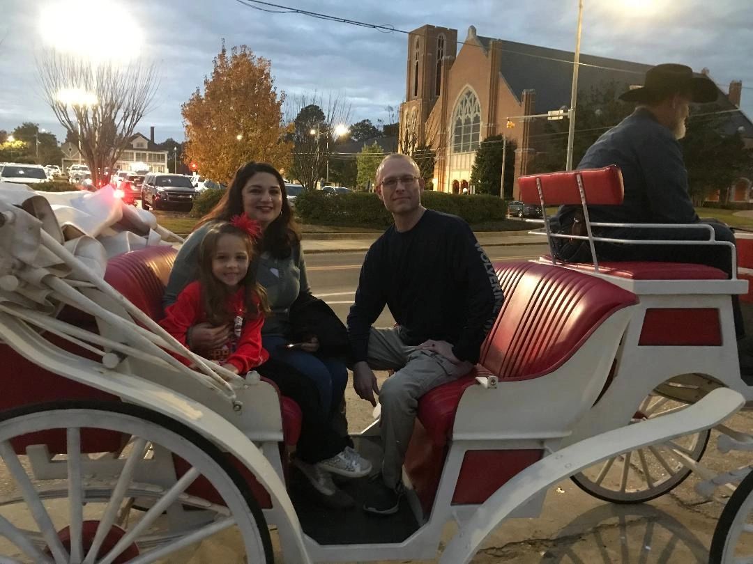 Family seated in a white vis-a-vis