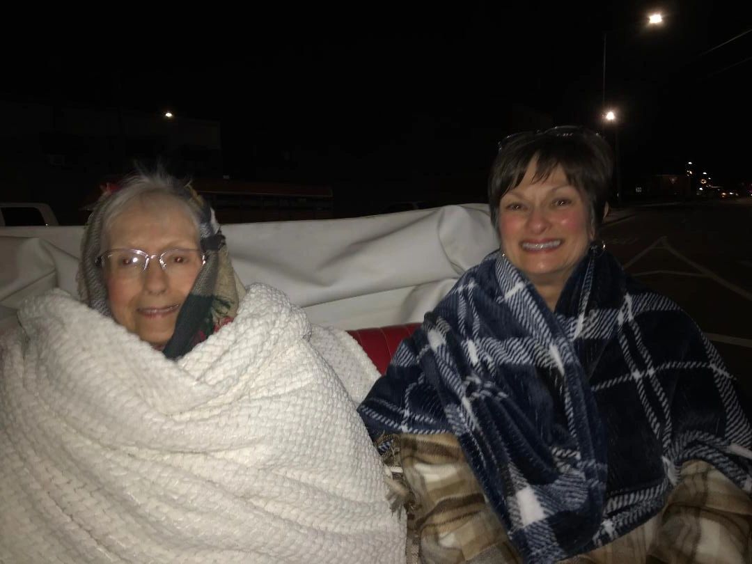 A mom and daughter on a white vis-a-vis