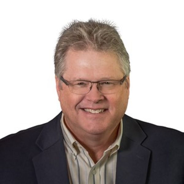 Smiling man in glasses and suit jacket