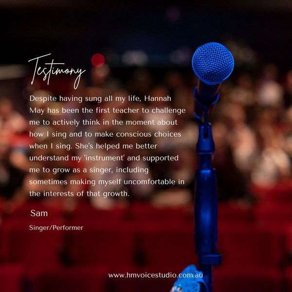 Blue microphone in focus on stage with a blurred audience and a singing testimony text overlay.