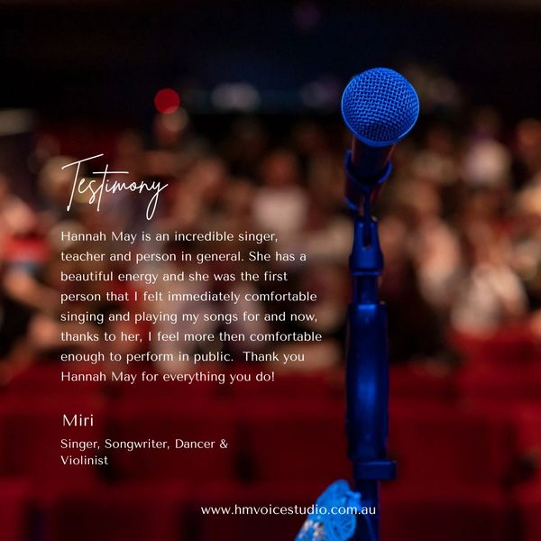 Microphone on stage with testimonial about singer Hannah May's impact.