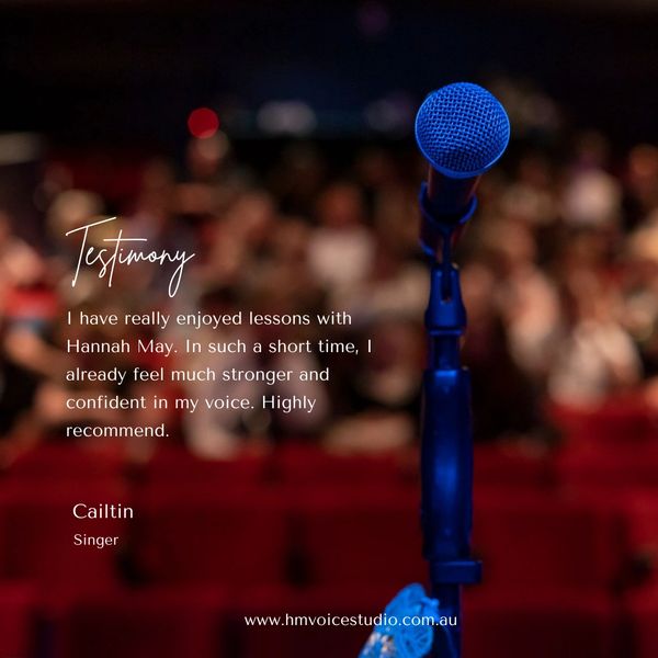 Blue microphone in focus with a blurred audience, featuring a singing lesson testimonial.