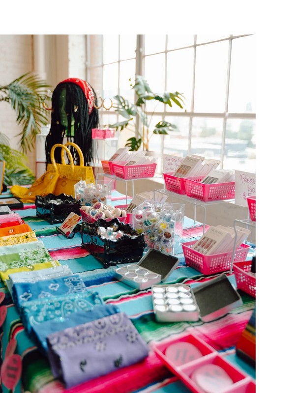 A merchandise display of products available from The Homegirl Hookup at a pop-up event.