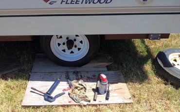 Greasing the hubs of the pop-up trailer