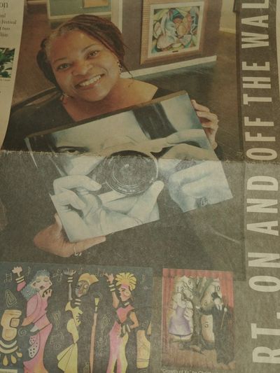 Woman proudly displays a creative photo collage artwork.