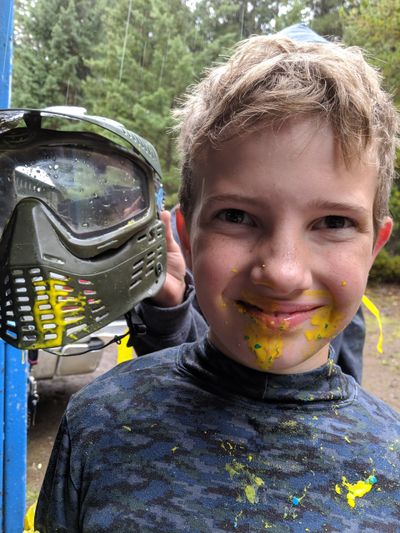 Kamloops Paintball Games young player covered in paint.