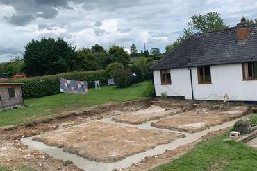 Concrete filled footings for building extension